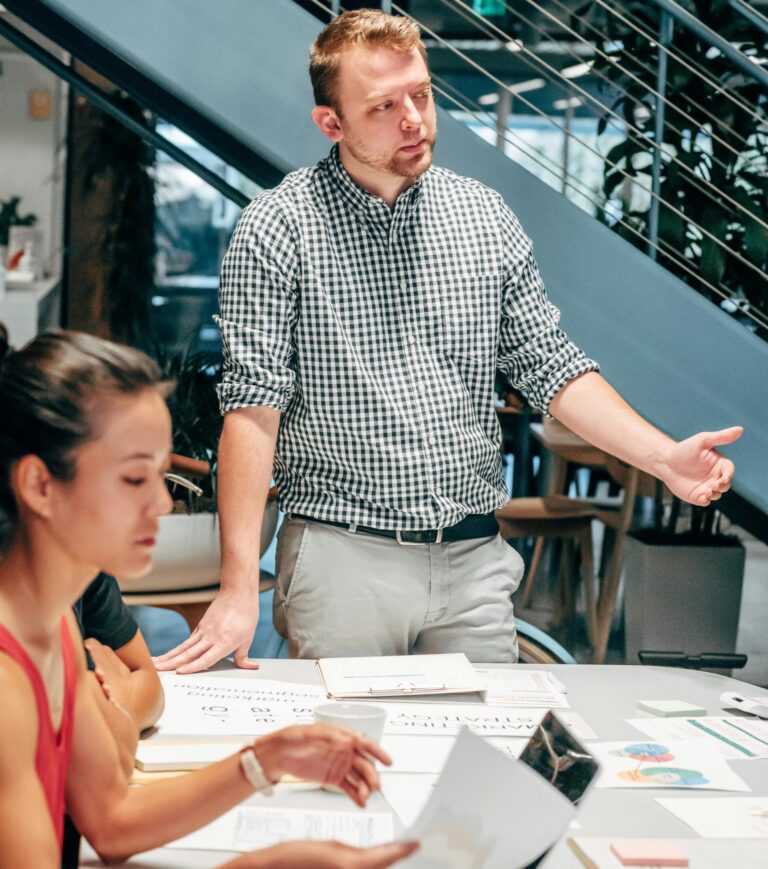 Diverse team collaborating in a modern office setting, discussing project details.